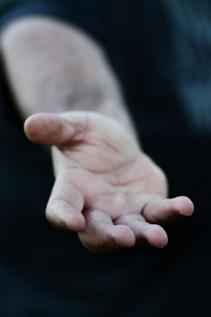 services-03 A close-up of an open hand reaching out, symbolizing help and friendship.