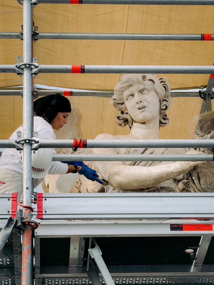 gallery-2 A conservationist meticulously restores an ancient statue in Rome, showcasing art preservation.