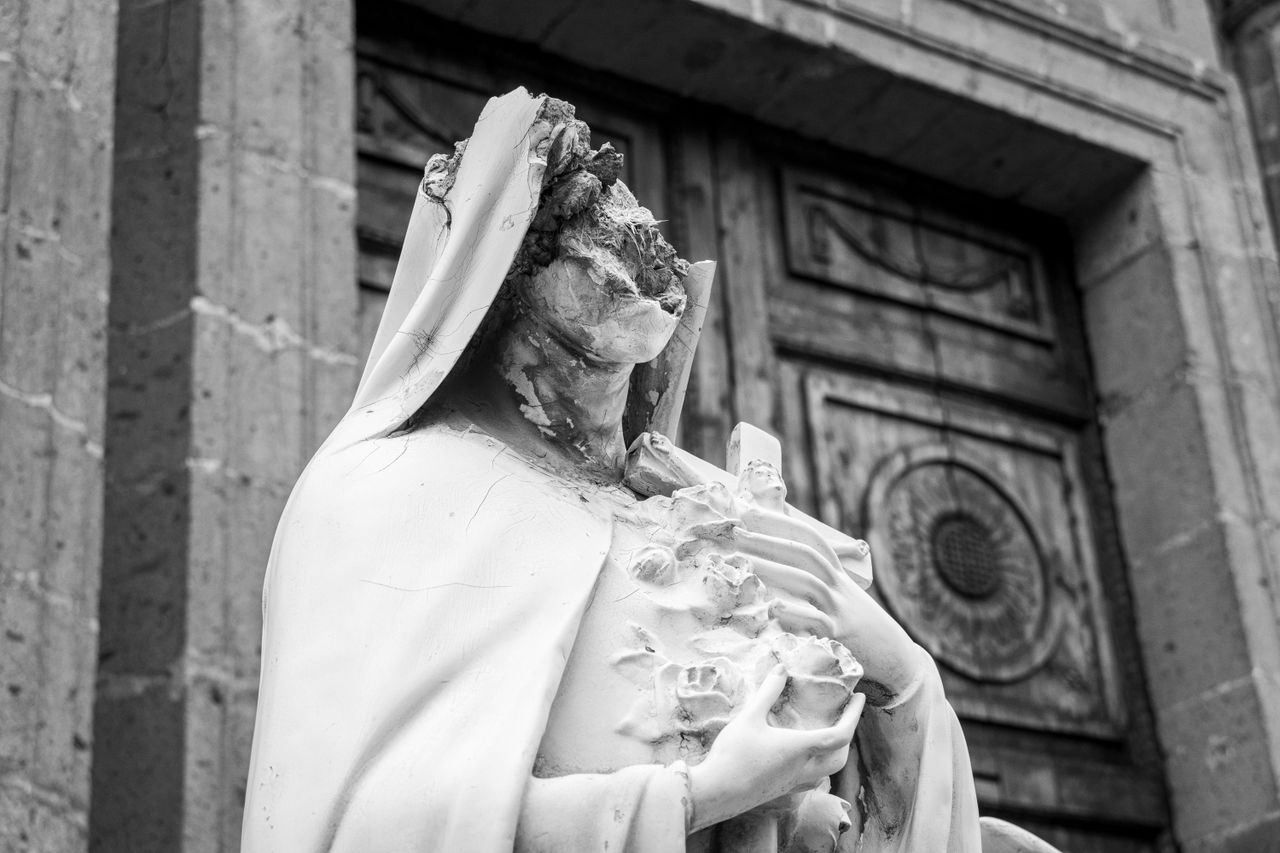 The Art of Drawing Readers In: Your attractive post title goes here A weathered white statue of Mary positioned outside a historic church in Mexico City.